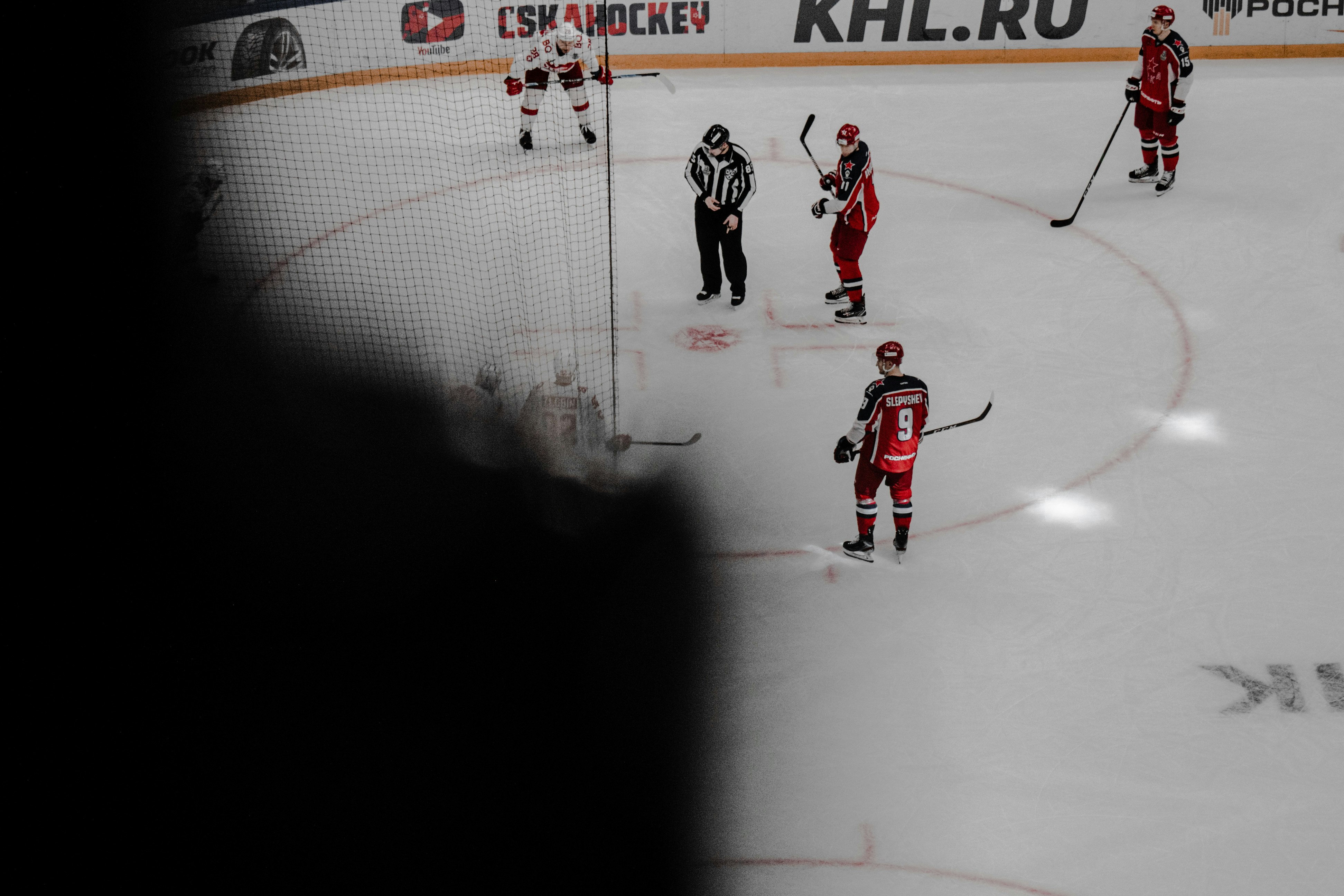 man in red jersey shirt playing hockey